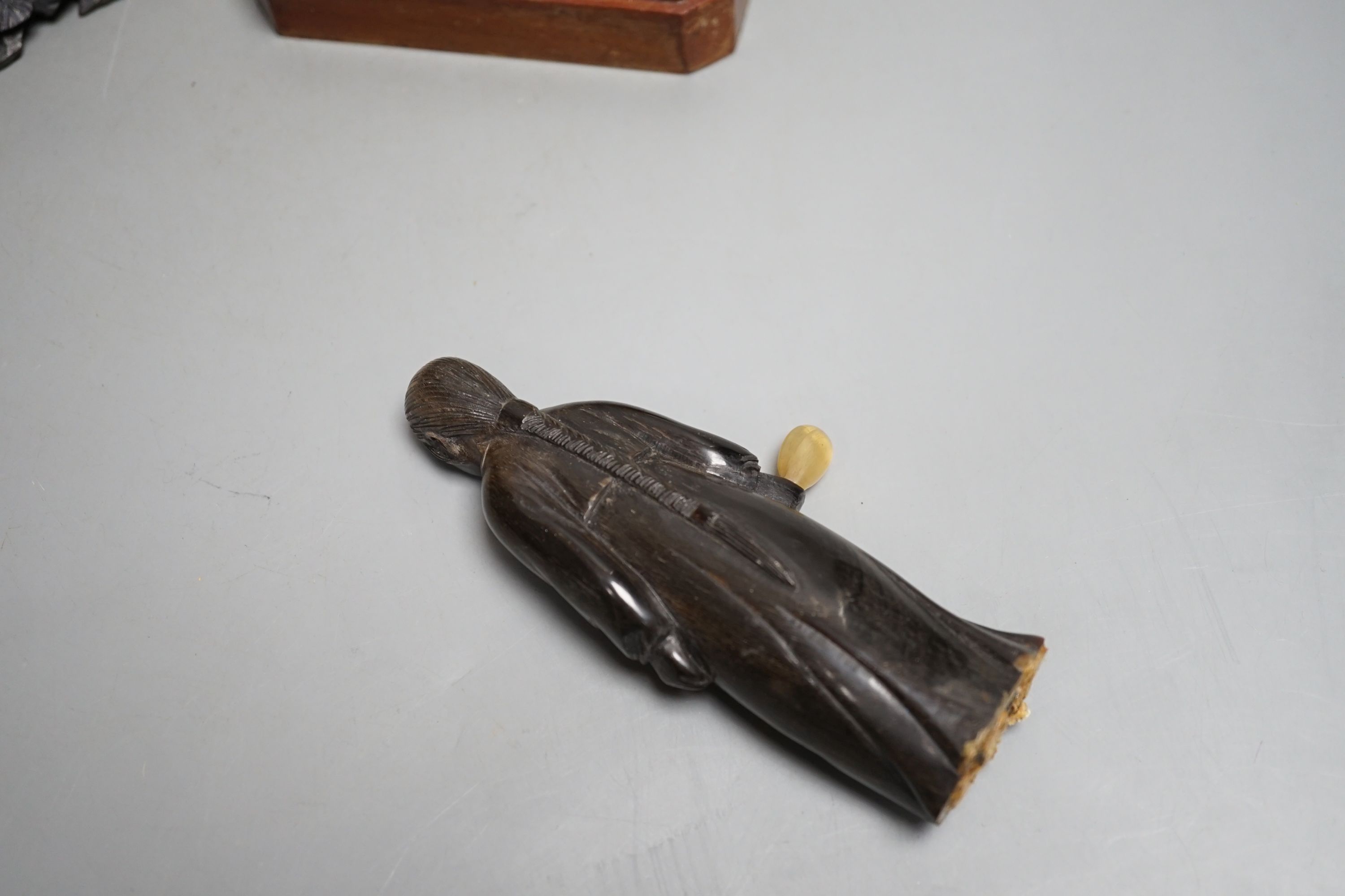 A Chinese horn figure and a carved hardwood figure riding a buffalo,13 cms wide.